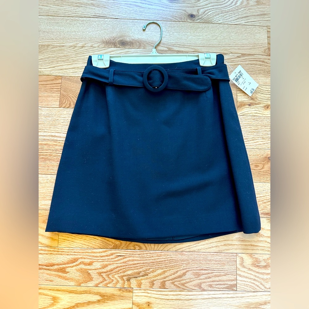 NWT INC black mini skirt. Zipper in back with cute built in belt. Size 8.
